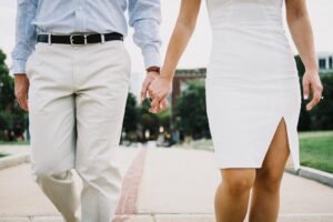 Powerful Valentine prayers for couples: A newly married couple praying together at sunrise, hands intertwined, with a soft glow of light symbolizing divine blessing.