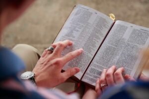 Powerful Valentine prayers for couples: Couple sitting together reading Bible or devotional